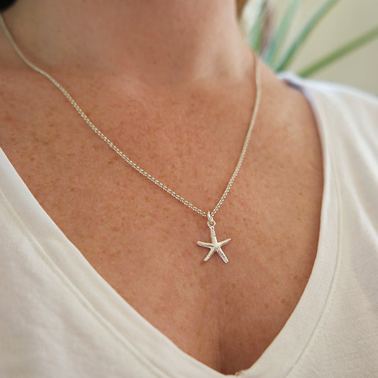 Zilveren zeester hanger aan een zilveren ketting. Handgemaakt zilveren zeester bedel